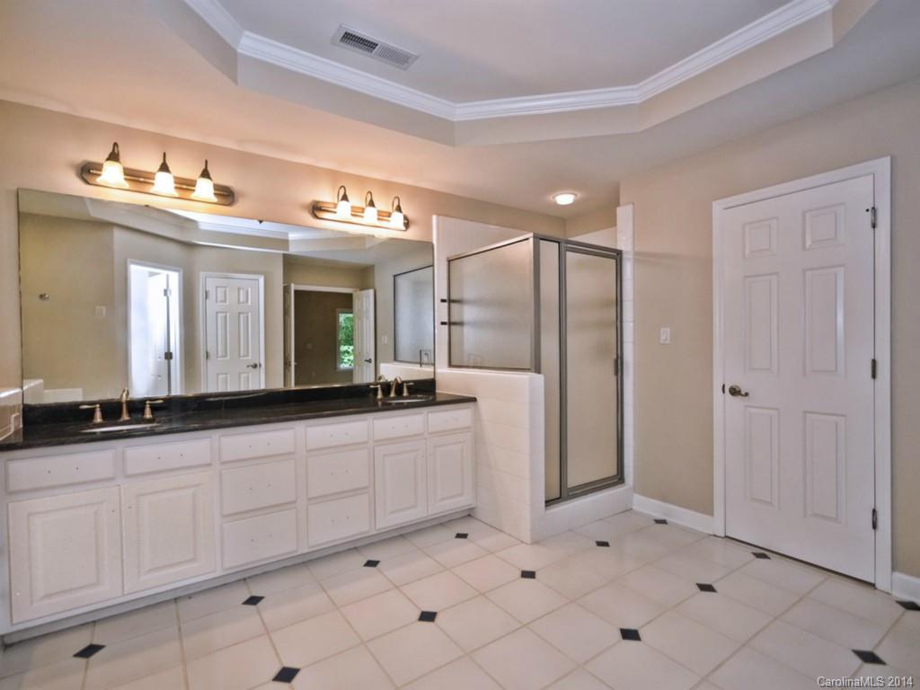 13504 Scanlan Way Davidson, NC 28036 - Photo 20 of 23 a bathroom with a sink a mirror and a shower