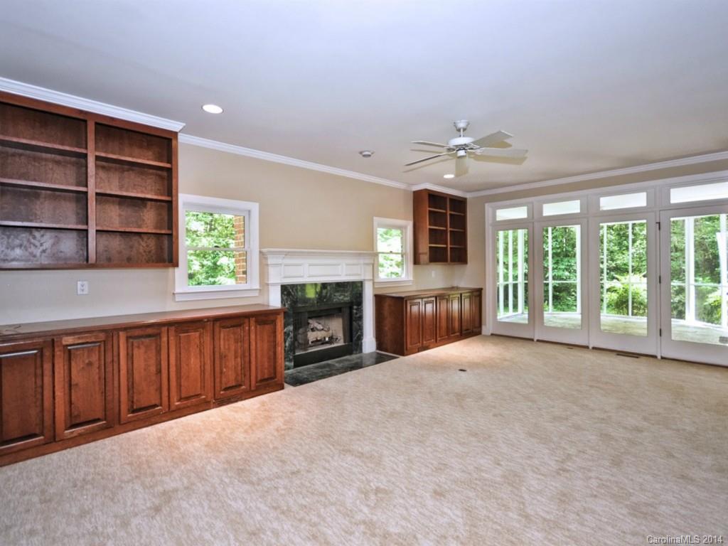 13504 Scanlan Way Davidson, NC 28036 - Photo 8 of 23 a view of an empty room with a fireplace and a window