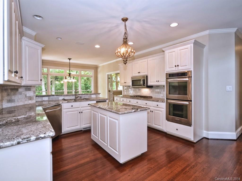 13504 Scanlan Way Davidson, NC 28036 - Photo 10 of 23 a kitchen with stainless steel appliances granite countertop a stove and a sink