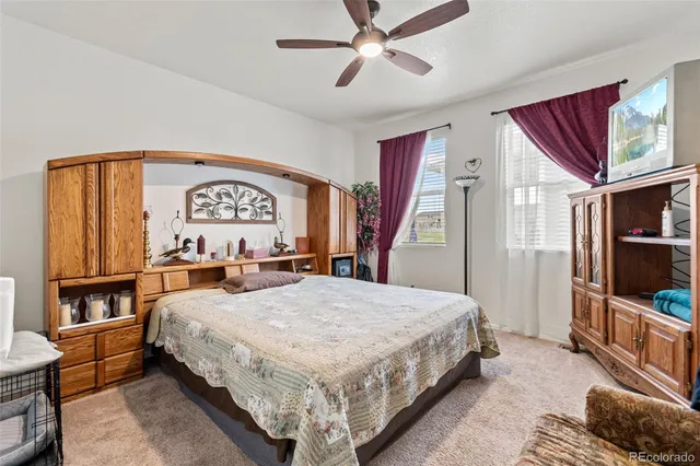 a bedroom with bed and wooden floor