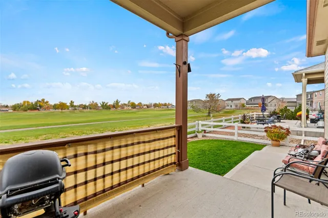 a view of a swimming pool with lawn chairs and a big yard