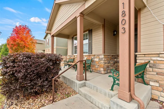 a view of a hallway with wooden floor and windows
