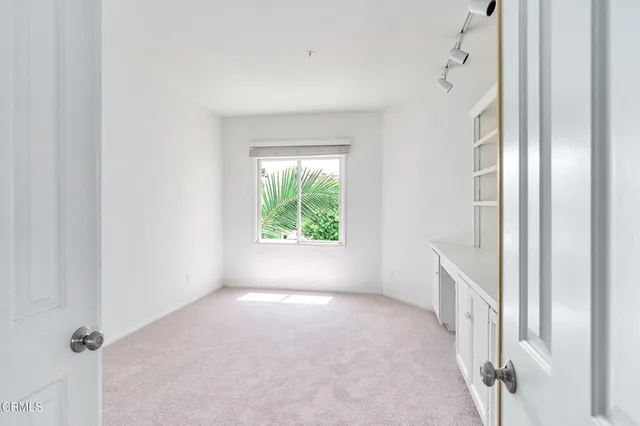 a view of an empty room with a window