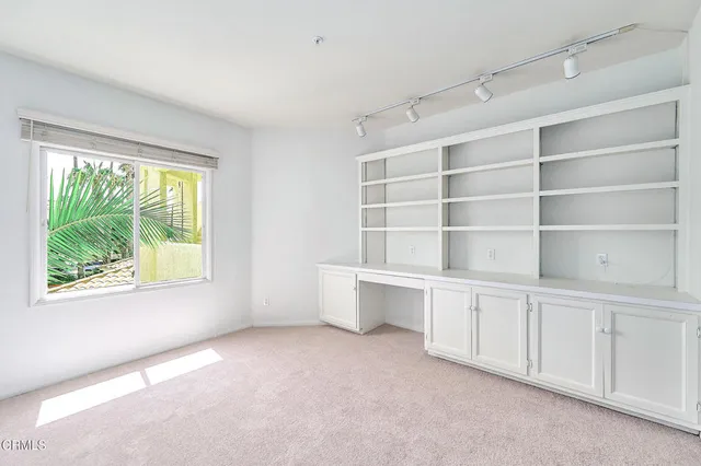 a view of an empty room with empty shelves