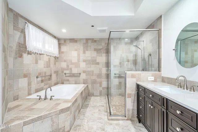 a spacious bathroom with a double vanity sink and a mirror
