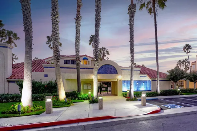 a view of a street with cars on the roadside