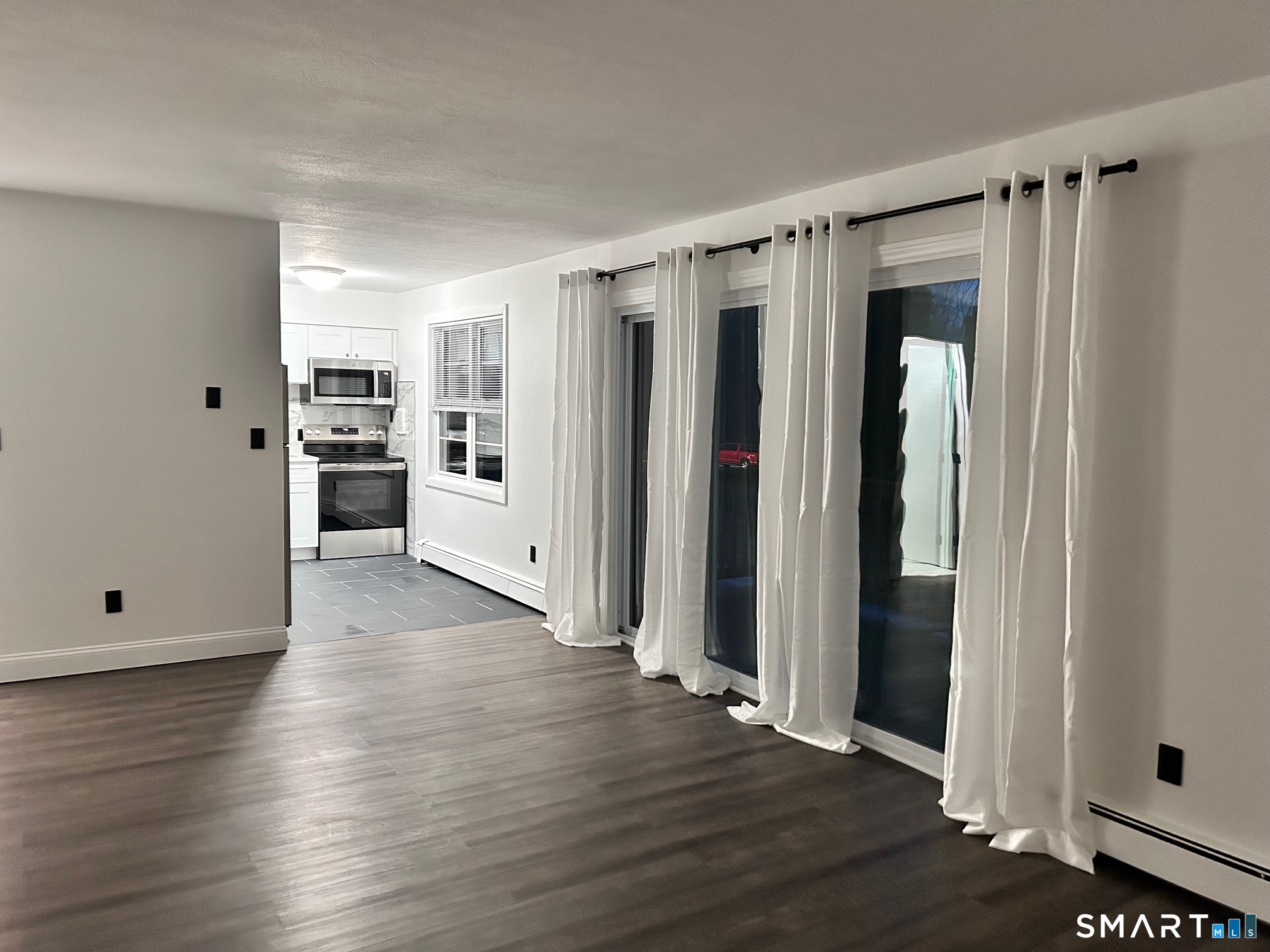 1109 Waterbury Road, Unit 1A Cheshire, CT 06410 - Photo 3 of 15 a view of a kitchen with wooden floor and electronic appliances