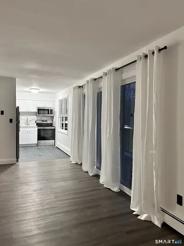 a view of a kitchen with a refrigerator and a stove