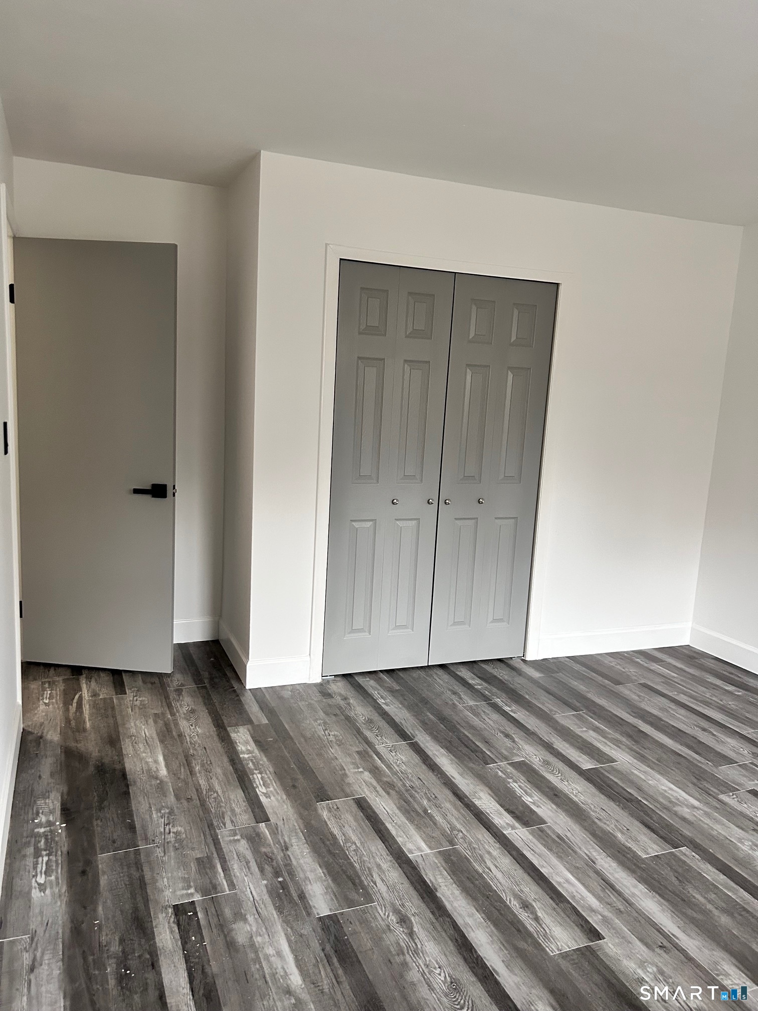 1109 Waterbury Road, Unit 1A Cheshire, CT 06410 - Photo 7 of 15 a view of empty room with wooden floor