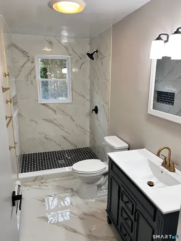 a bathroom with a sink toilet and shower