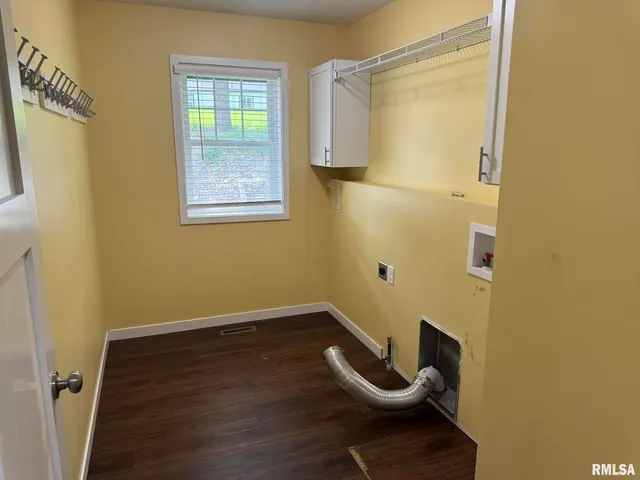 a view of a small space with wooden floor and furniture