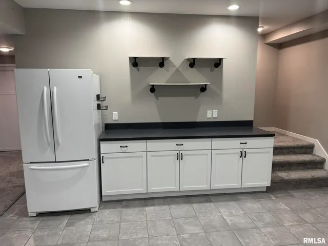 a white refrigerator freezer sitting inside of a kitchen