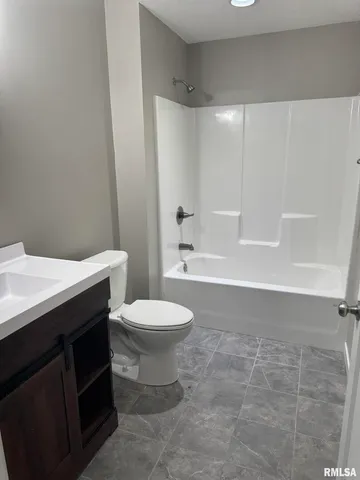 a bathroom with a toilet a sink and bathtub