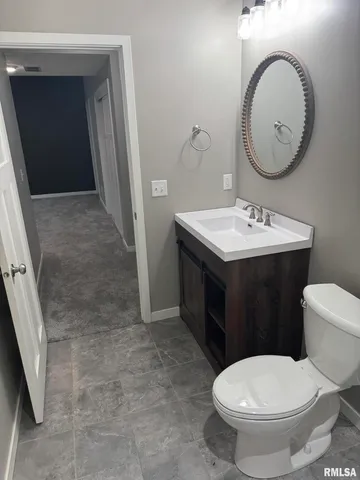 a bathroom with a toilet a sink and a mirror