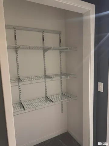 a view of an house with backyard and a tree