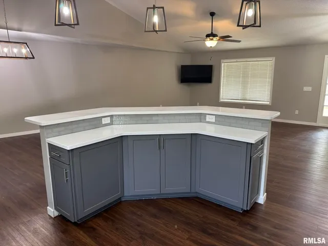 a kitchen with a wooden floor and a window