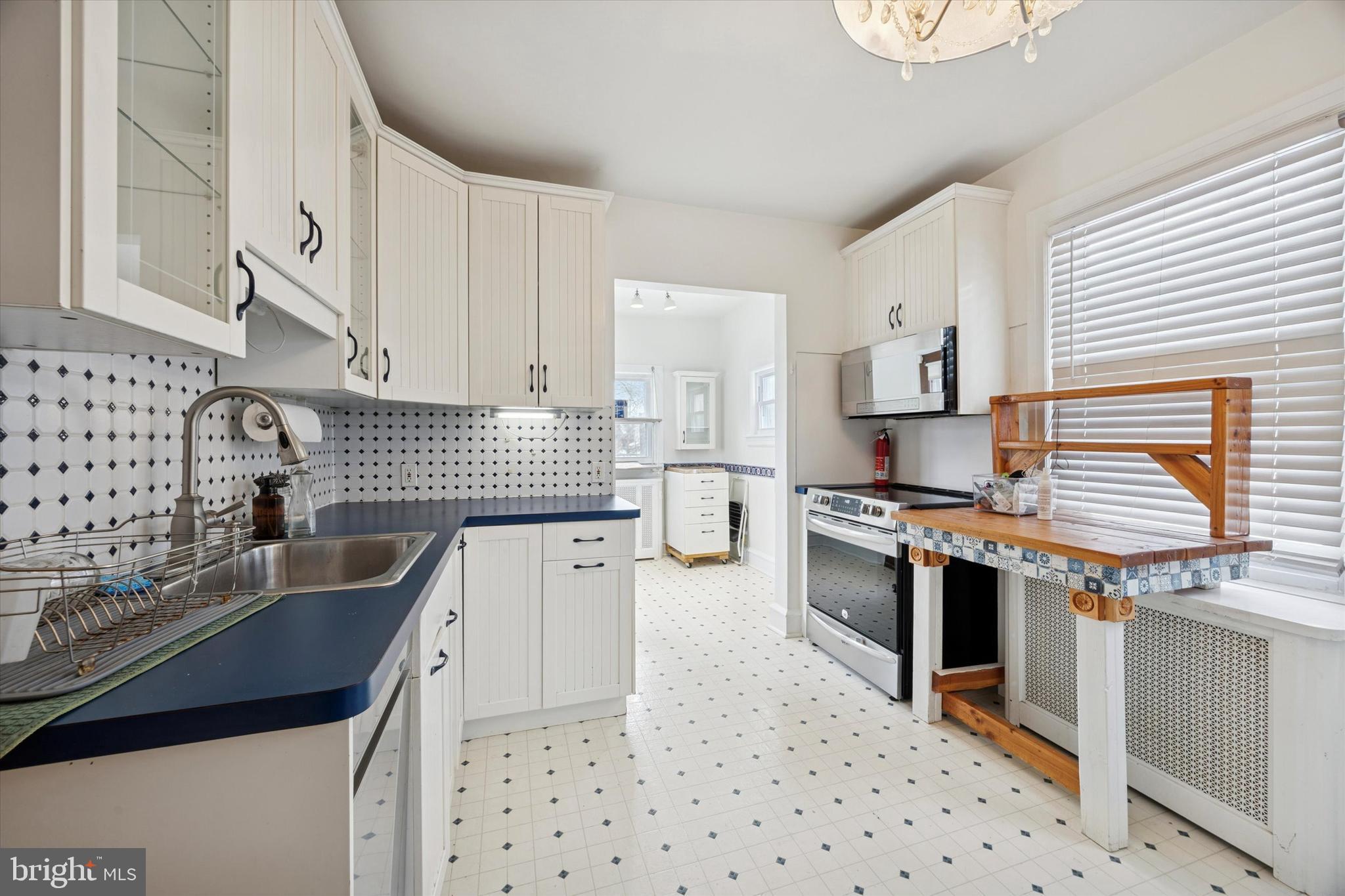 74 Drexel Avenue Lansdowne, PA 19050 - Photo 6 of 15 a kitchen with granite countertop a sink stove and cabinets