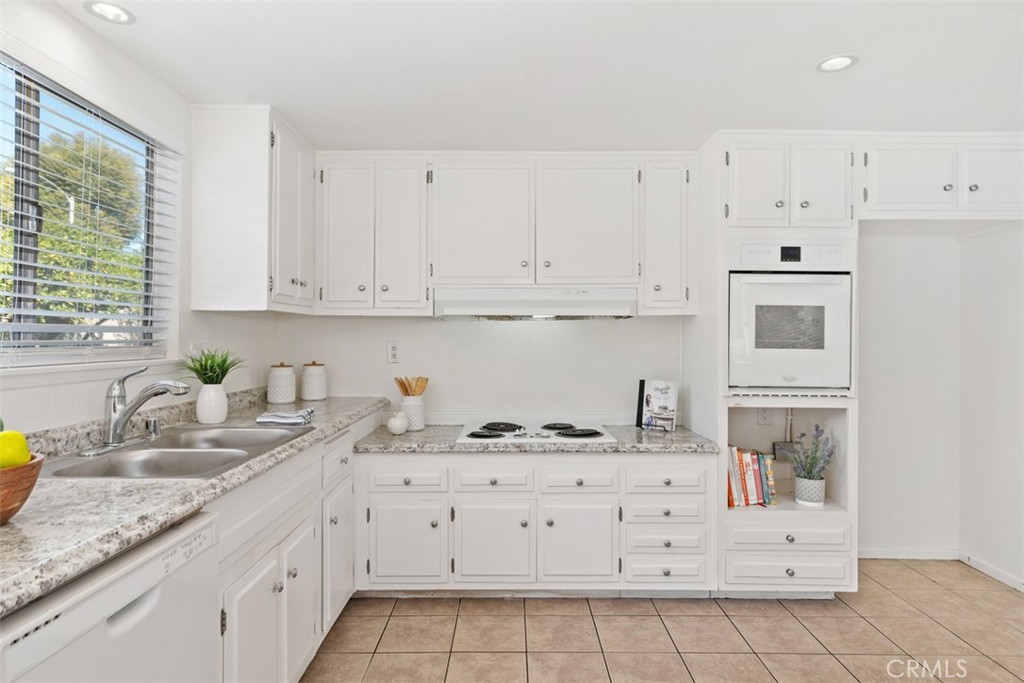 945 Redbud Street Brea, CA 92821 - Photo 13 of 31 a kitchen with granite countertop a sink stove and cabinets