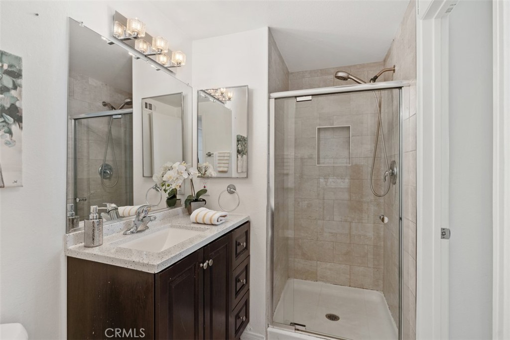 945 Redbud Street Brea, CA 92821 - Photo 19 of 31 a bathroom with a shower sink vanity and mirror