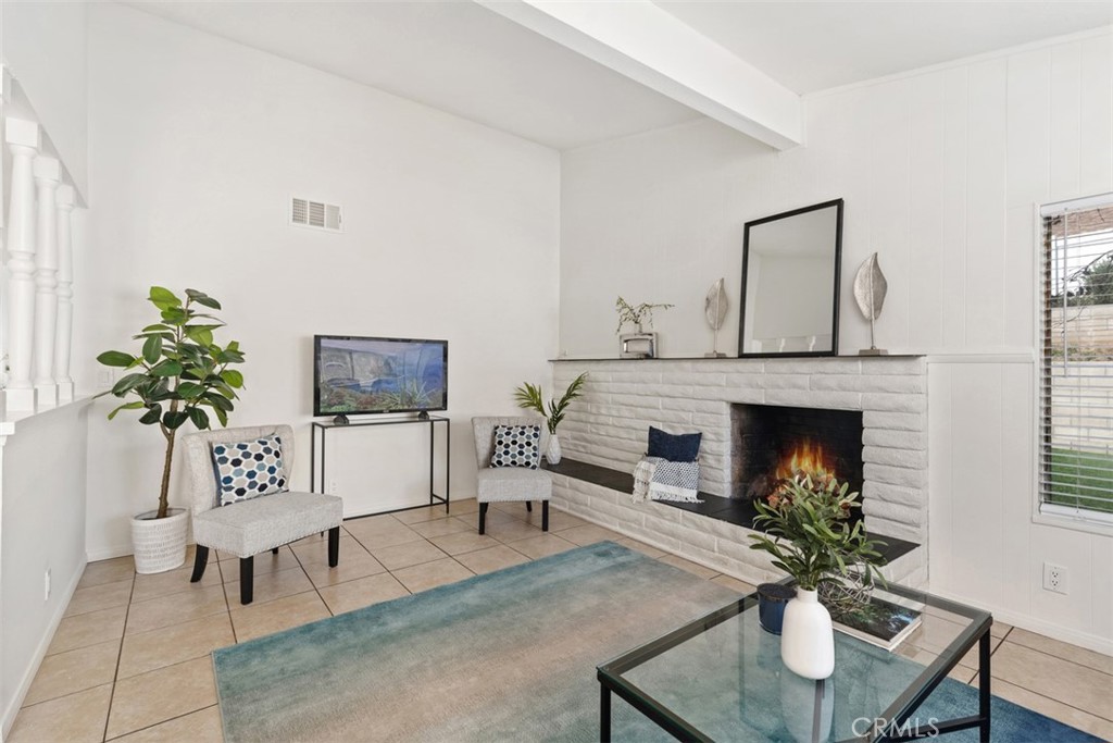 945 Redbud Street Brea, CA 92821 - Photo 6 of 31 a living room with furniture a potted plant and a fireplace
