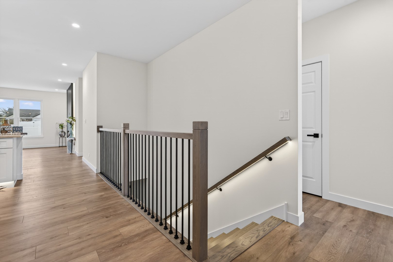 1002 Joshua Lane Genoa, IL 60135 - Photo 2 of 42 a view of a hallway with wooden floor