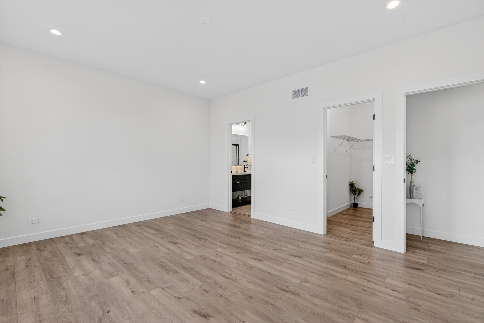 1002 Joshua Lane Genoa, IL 60135 - Photo 21 of 42 a view of an empty room with wooden floor and stairs