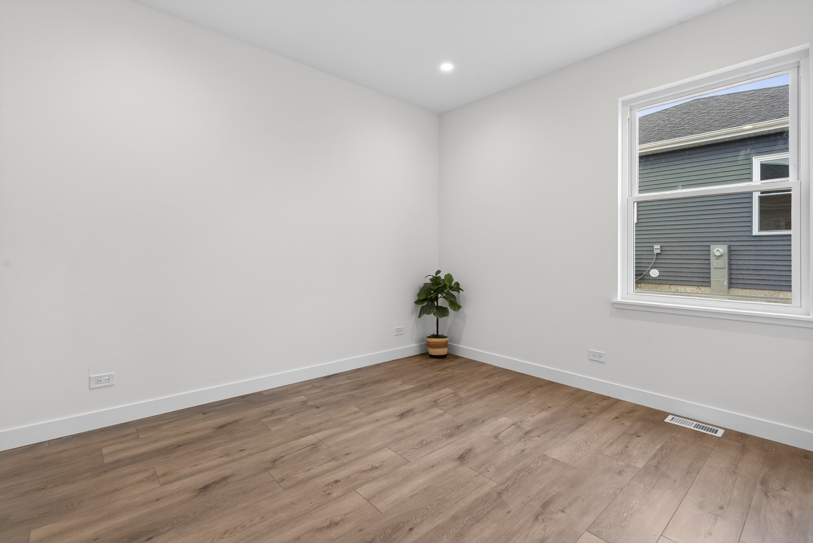 1002 Joshua Lane Genoa, IL 60135 - Photo 26 of 42 a view of an empty room with wooden floor and a window
