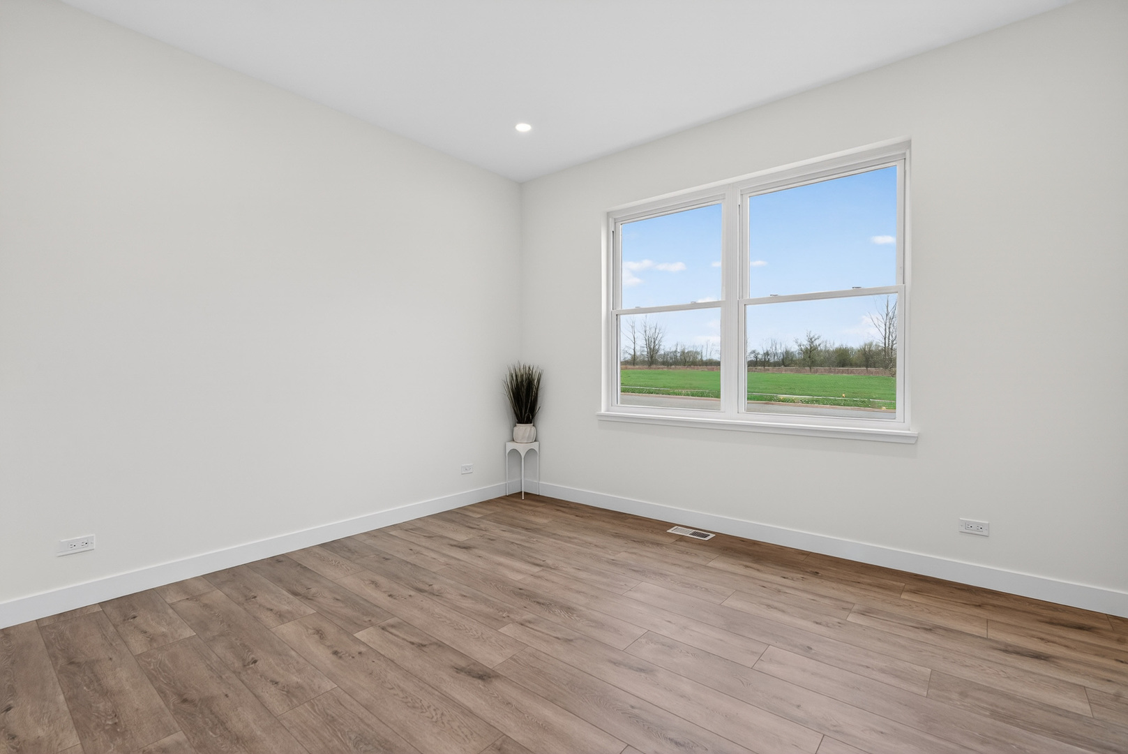 1002 Joshua Lane Genoa, IL 60135 - Photo 27 of 42 wooden floor in an empty room with a window