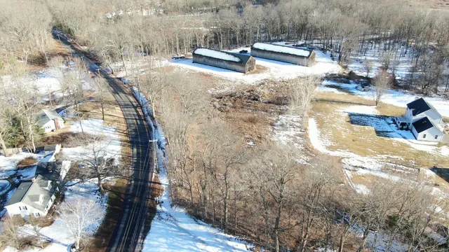 an aerial view of house with yard and mountain view in back
