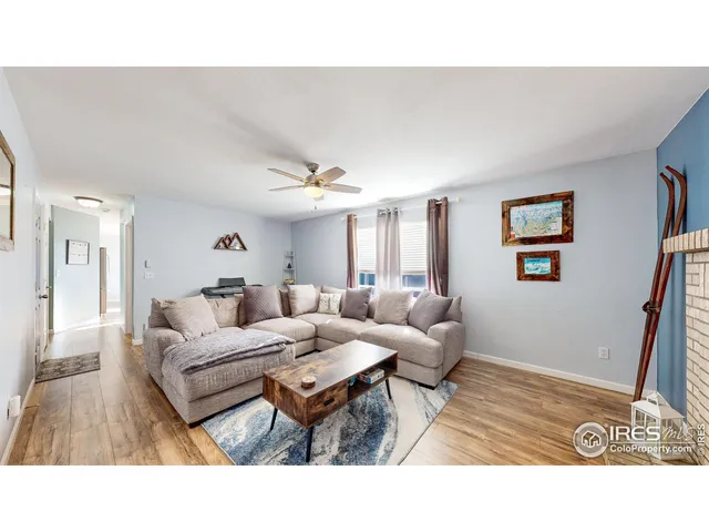 a living room with furniture and a dining table