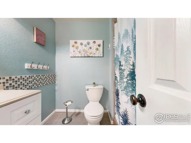 a bathroom with a toilet a sink and garden