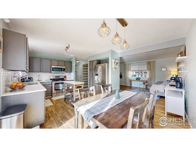 a living room with lots of furniture and kitchen view