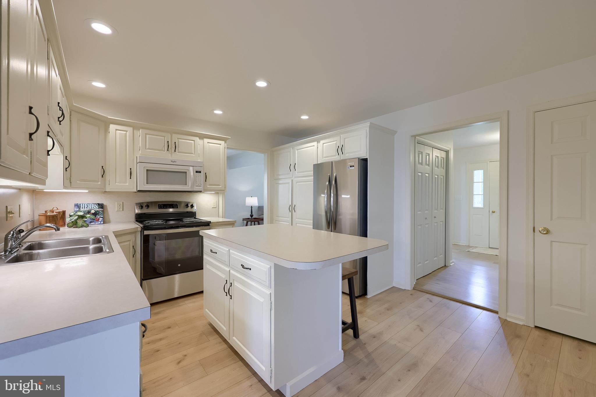 1 Brookwood Drive Lititz, PA 17543 - Photo 19 of 42 a kitchen with stainless steel appliances kitchen island a sink dishwasher a refrigerator and a stove with wooden floor