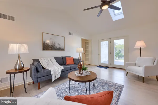 a living room with furniture and a lamp