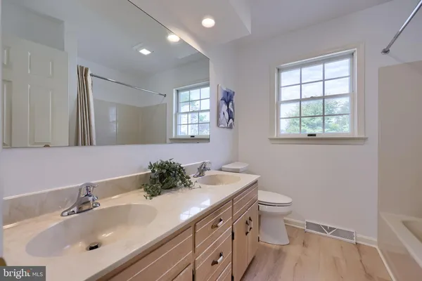 a bathroom with a sink toilet and mirror