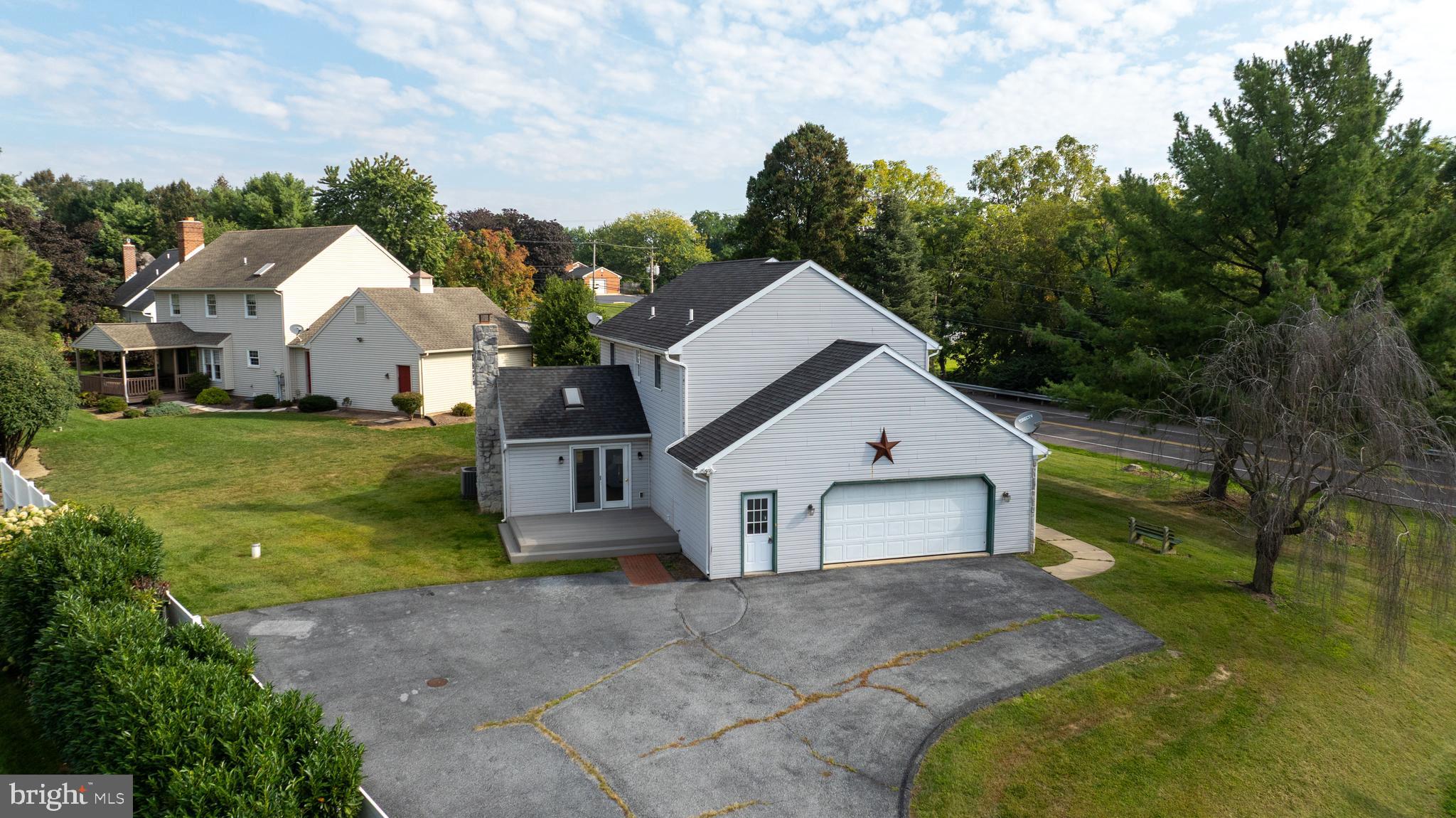 1 Brookwood Drive Lititz, PA 17543 - Photo 40 of 42 a view of a white house next to a yard with big trees