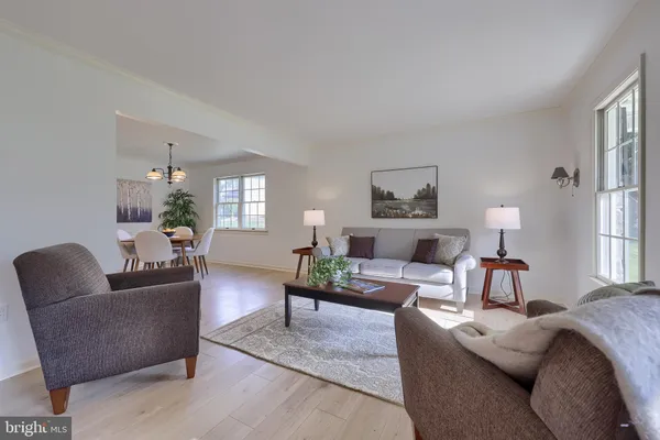 a living room with furniture and a lamp