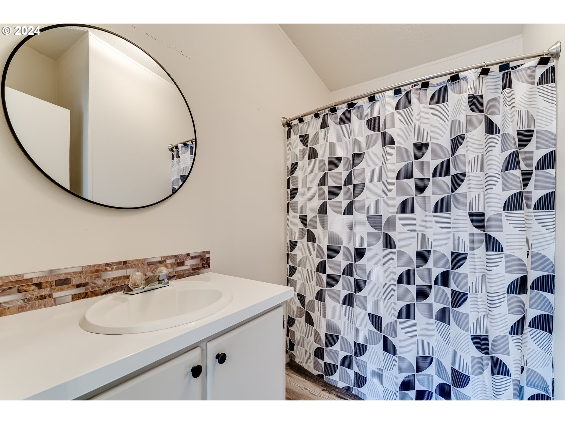 301 Smith Loop Springfield, OR 97478 - Photo 15 of 32 a bathroom with a sink mirror and a shower