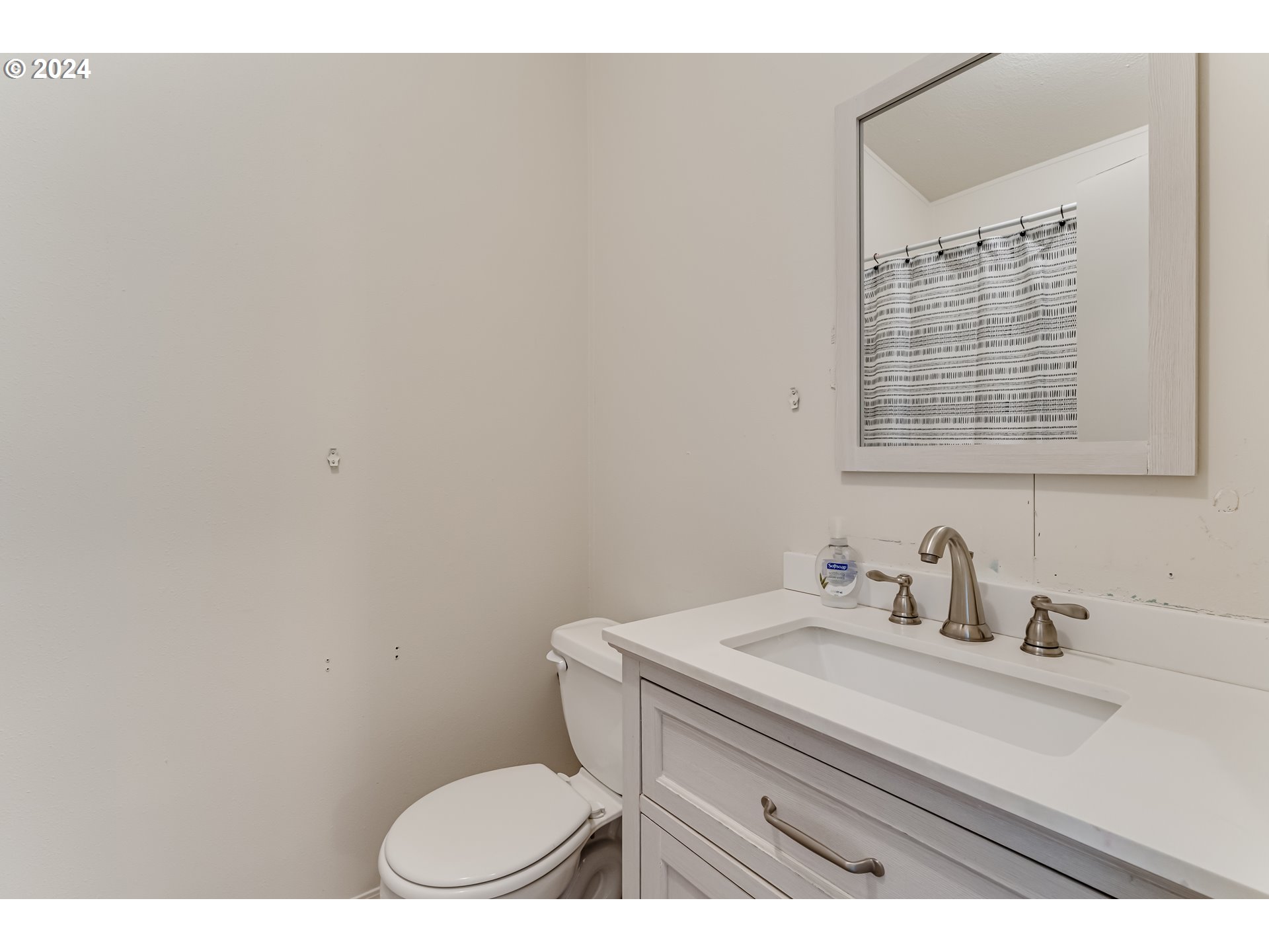 301 Smith Loop Springfield, OR 97478 - Photo 25 of 32 a bathroom with a sink a toilet and a mirror