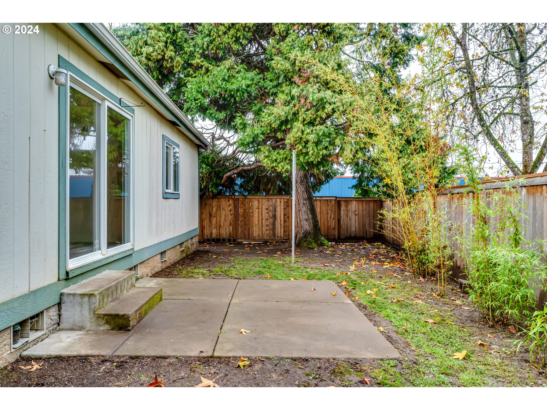 301 Smith Loop Springfield, OR 97478 - Photo 28 of 32 a backyard of a house with a bench and trees