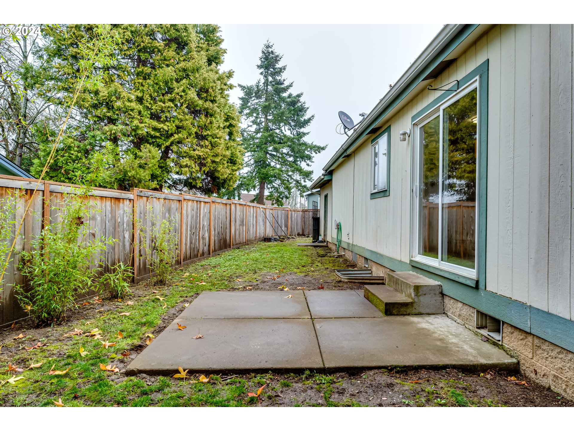 301 Smith Loop Springfield, OR 97478 - Photo 29 of 32 a backyard of a house with plants and trees with wooden fence