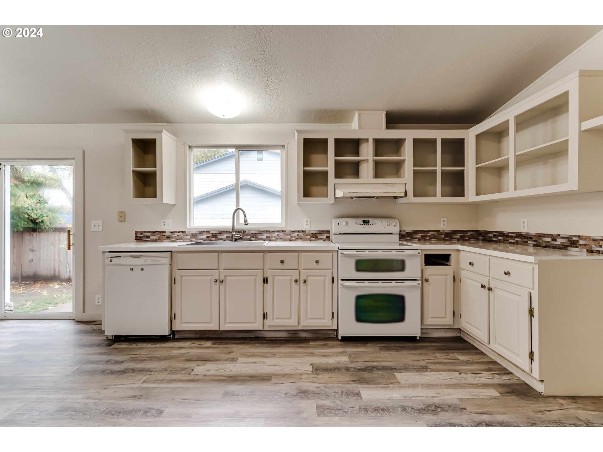 301 Smith Loop Springfield, OR 97478 - Photo 8 of 32 a kitchen with stainless steel appliances granite countertop a stove a sink and a microwave