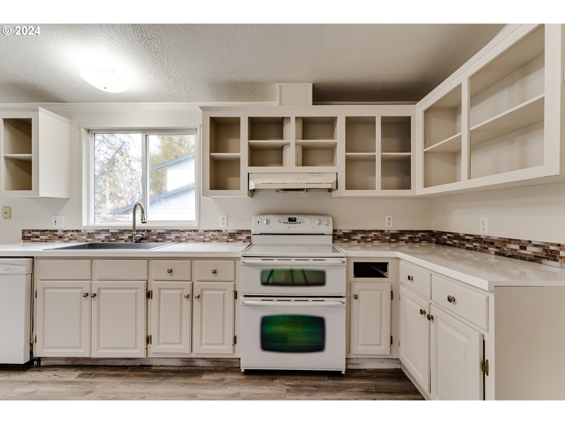 301 Smith Loop Springfield, OR 97478 - Photo 9 of 32 a kitchen with stainless steel appliances granite countertop a stove and a white cabinets