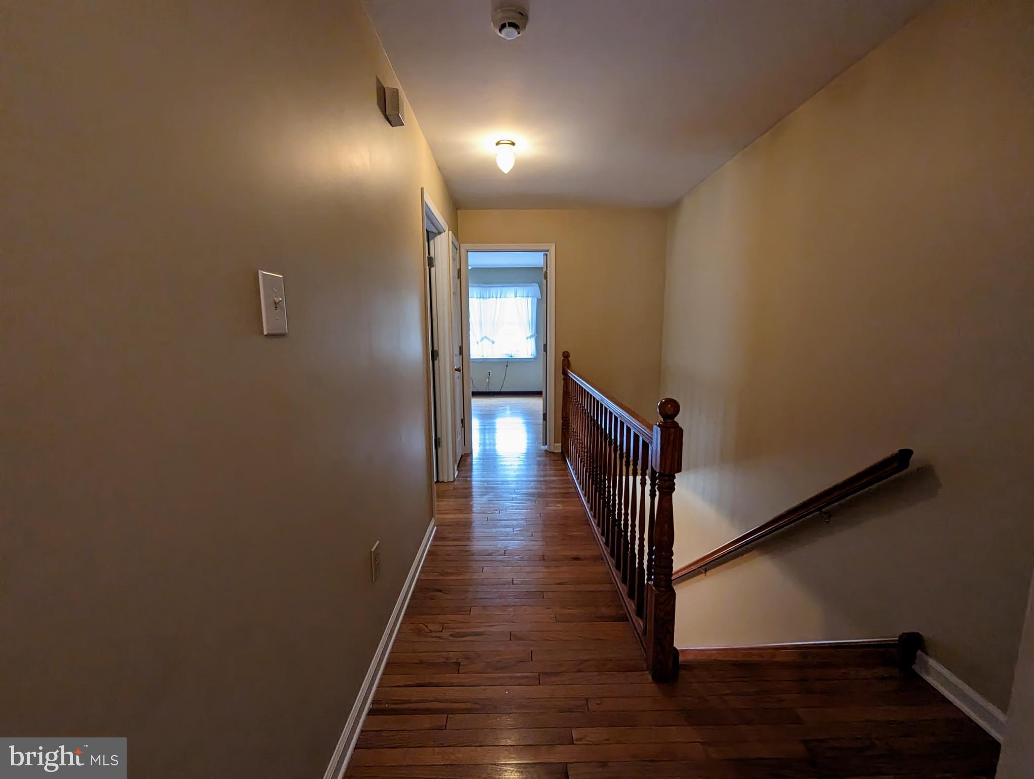 612 Ridgeway Street Gloucester City, NJ 08030 - Photo 14 of 28 Upstairs hall with hardwood floors and railings.