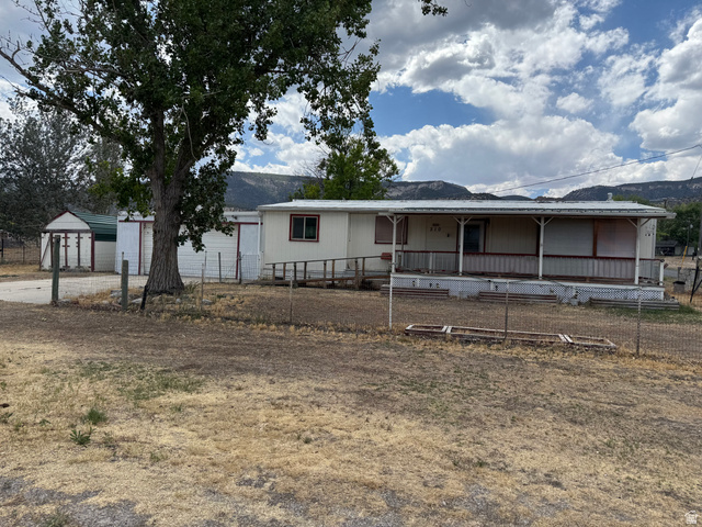 210 South State Street Moroni, UT 84646 - Photo 23 of 23 Single-story residence featuring a covered front porch, a ramp entry, and an established mature tree