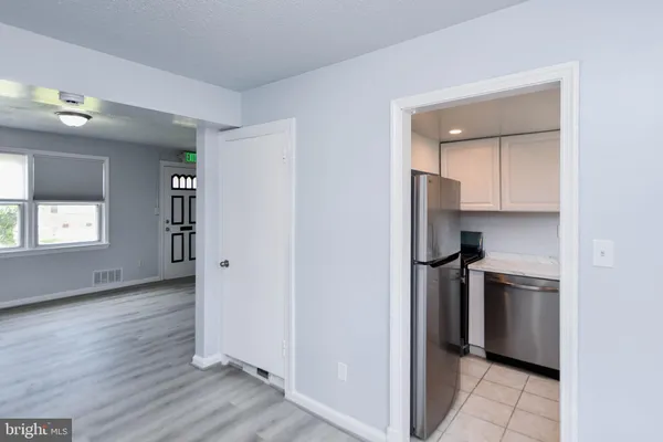 a view of kitchen with a refrigerator cabinets and a sink
