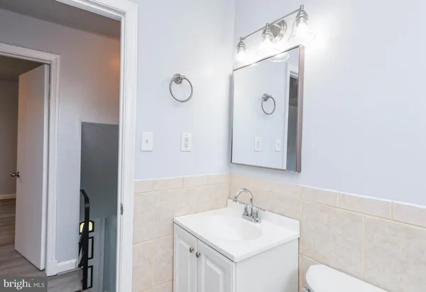 a bathroom with a sink mirror and vanity