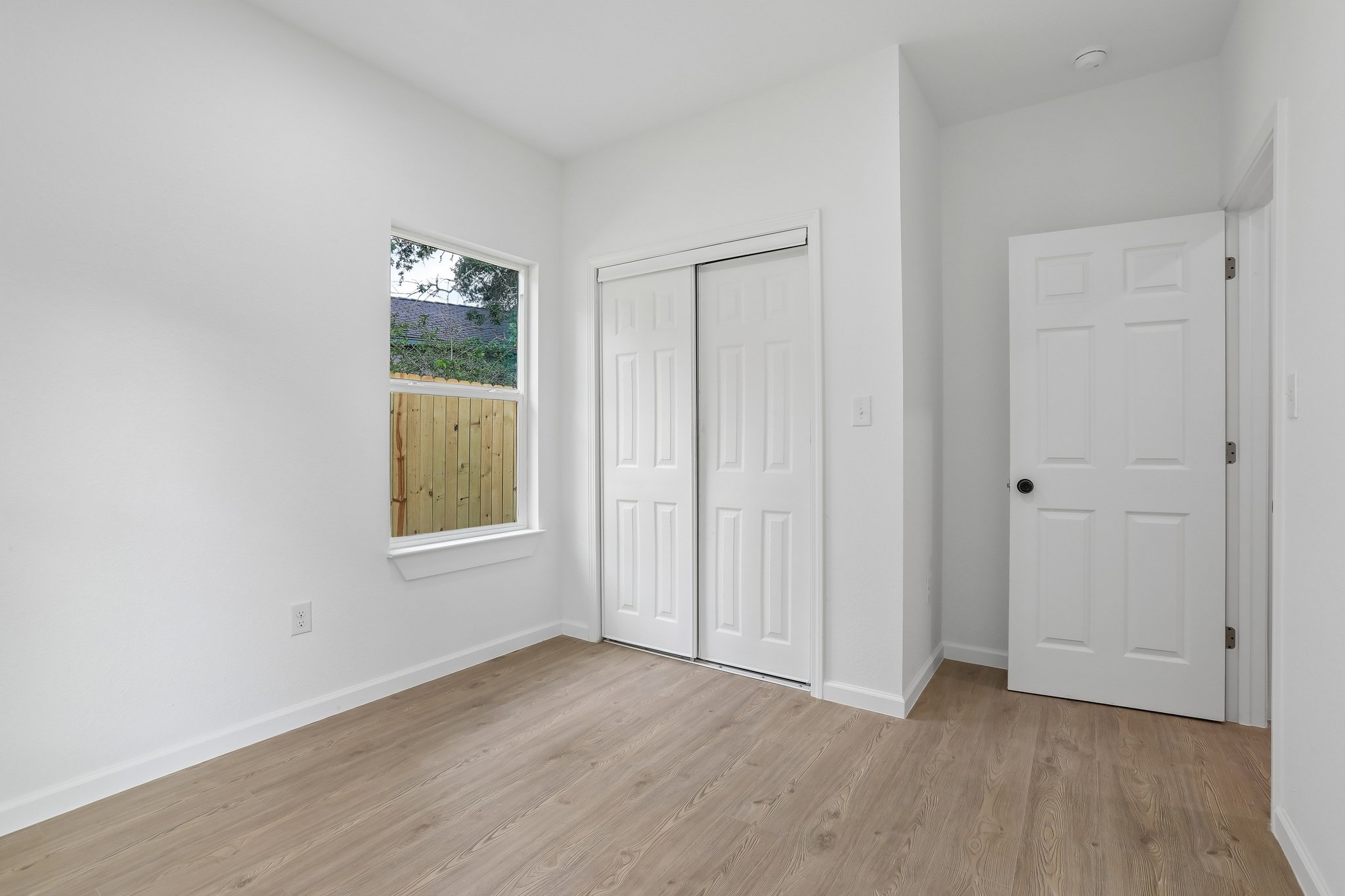 210 Flint Ridge Street Bastrop, TX 78602 - Photo 28 of 40 an empty room with wooden floor and windows