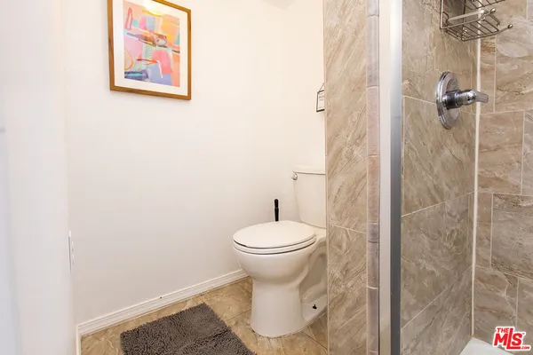 a bathroom with a toilet and a shower