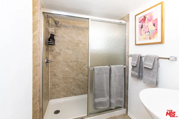 a bathroom with a shower and a tub